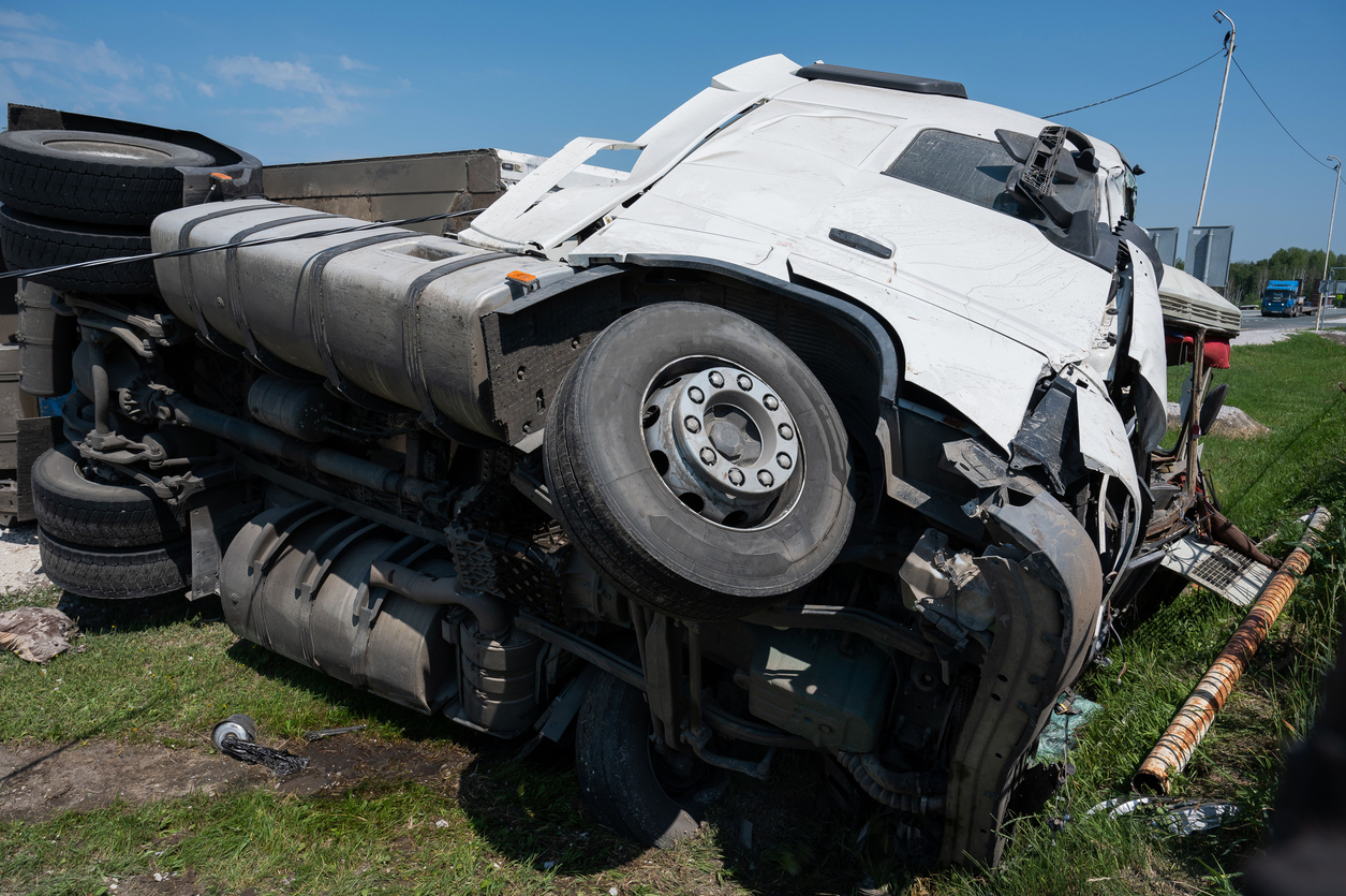 A Route 14 rollover crash occurred when debris on the road caused a gray truck to crash.
